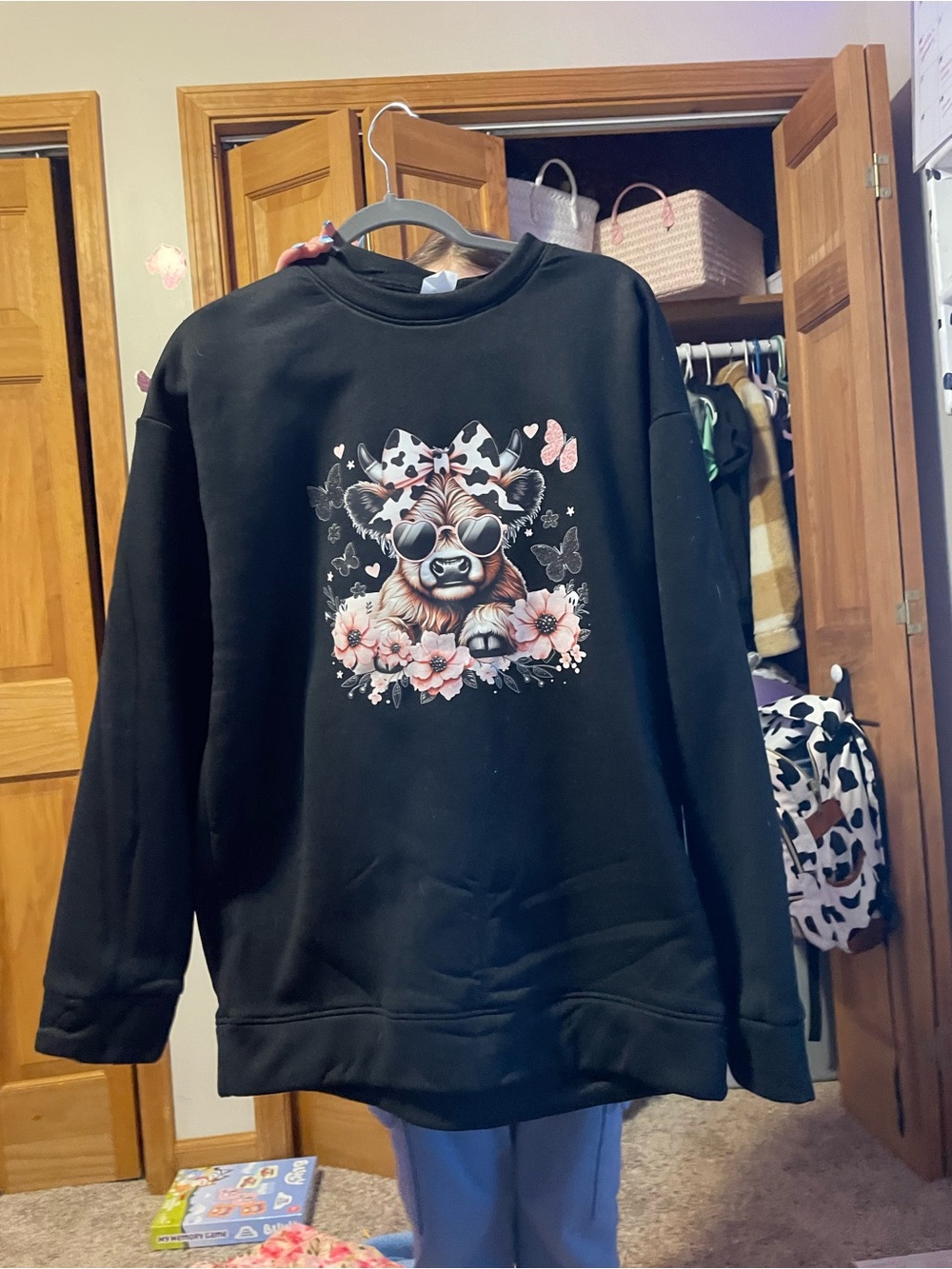Amazon Black Crewneck Sweatshirt with Pink Floral Cow Illustration